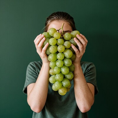 Woman holding green grapes