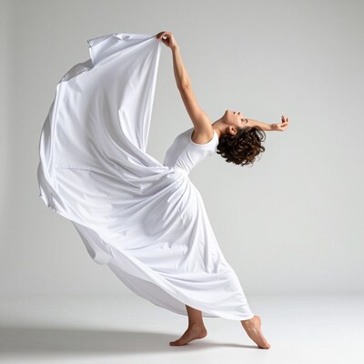 Woman in flowing white dress dancing
