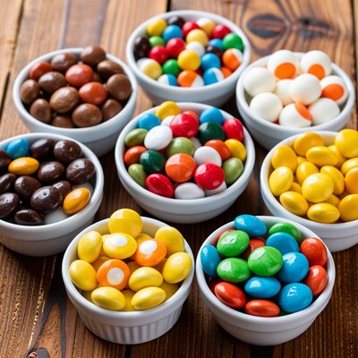 Colorful candy bowls on wood