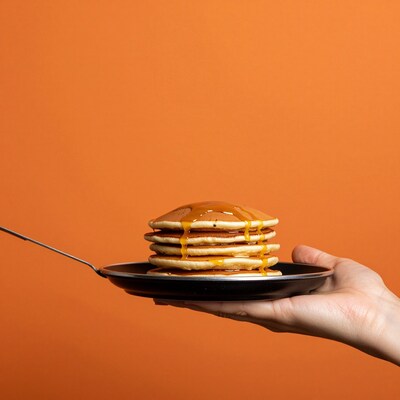 Hand holding pancake stack
