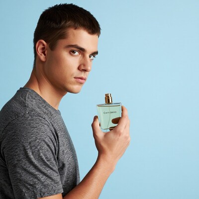Man holding perfume bottle