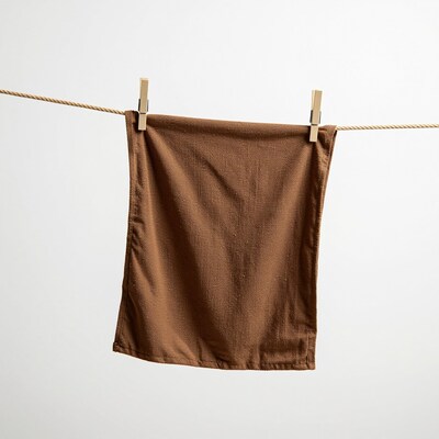 Brown towel hanging on clothesline