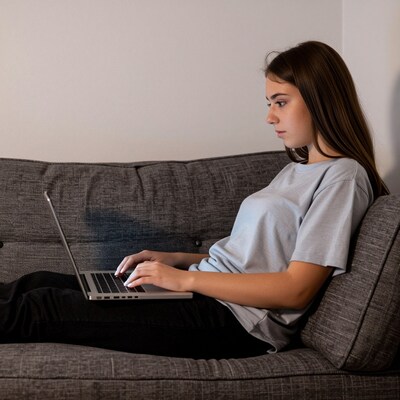 Young woman using laptop on couch