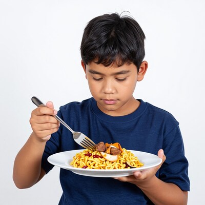 Young Asian boy eating noodles