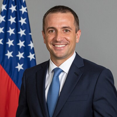 Smiling Man in Suit with American Flag