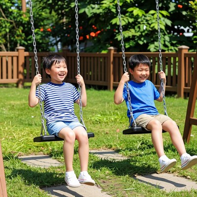 Two Asian boys swinging