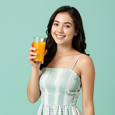 Smiling woman holding orange juice