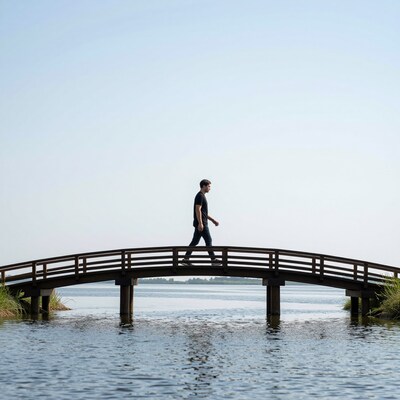 Man walking on wooden bridge
