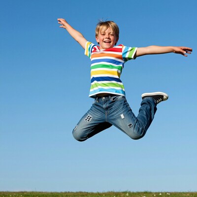 Happy boy jumping in air