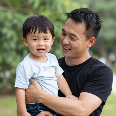 Asian father holding son
