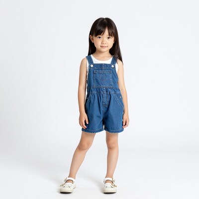 Young Asian girl in denim overalls