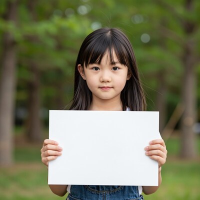 Young Asian girl holding blank sign