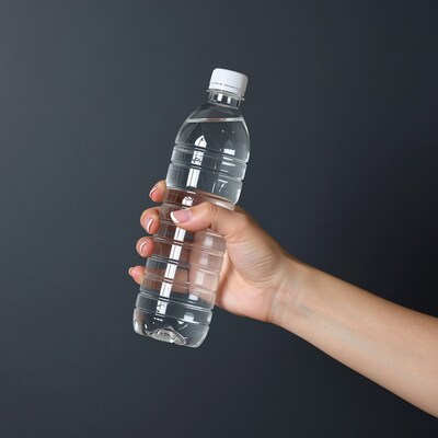 Hand holding plastic water bottle