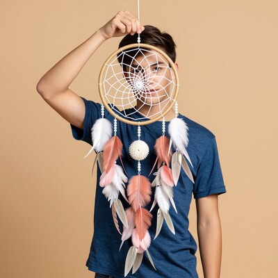 Teen boy holding dreamcatcher