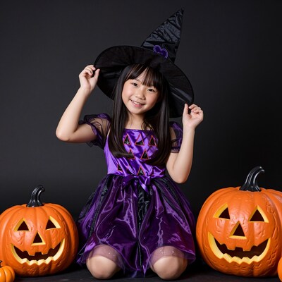 Young Asian girl in witch costume
