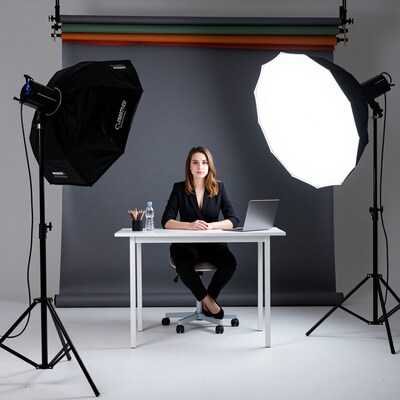 Woman in black suit at office desk in photo studio