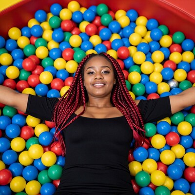 Woman in ball pit smiling