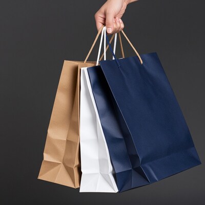 Hand holding shopping bags