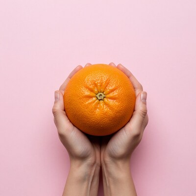 Hands holding orange fruit