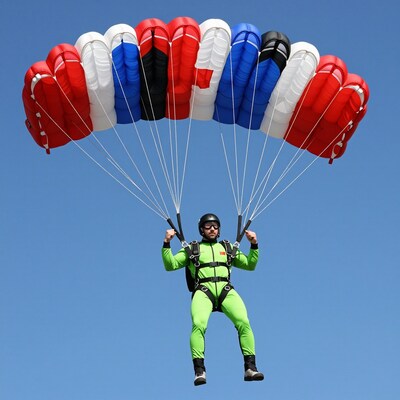 Skydiver with colorful parachute