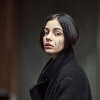 Sad woman with black tears