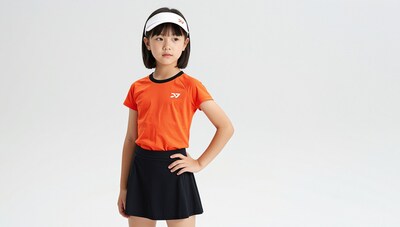 Young Asian girl in orange tennis outfit
