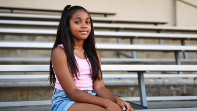Young Black Girl Sitting on Bleachers