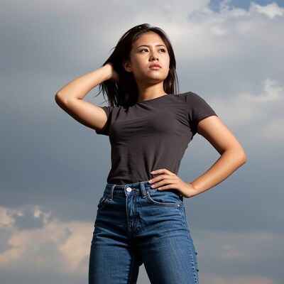 Young Asian woman posing against sky