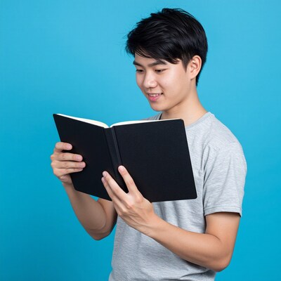 Young Asian man reading book