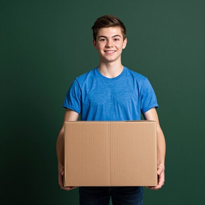Teen boy holding cardboard box