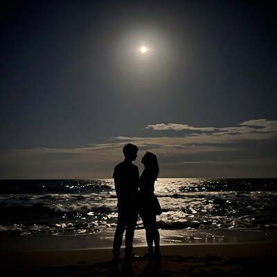 Romantic couple silhouette on beach at night